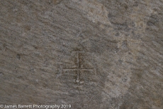 A mason's mark on one of the foundation stones.